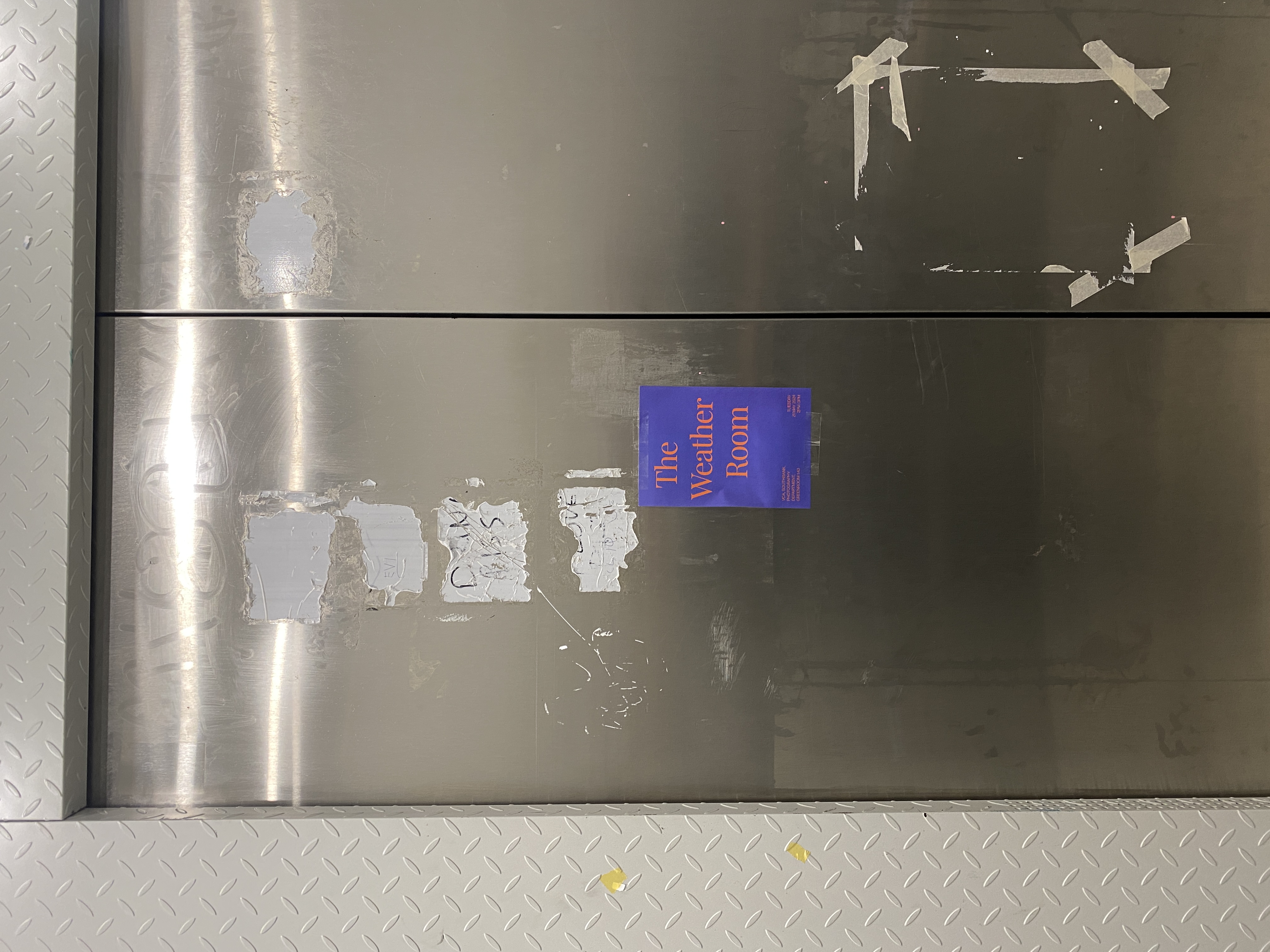 The Weather Room — elevator interior, mirrored surfaces and ceiling lights